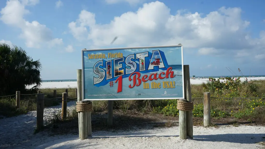 Siesta Key beach sign in Siesta Key, Florida, a helpful visual for first-time visitors planning the best time to visit Siesta Key.