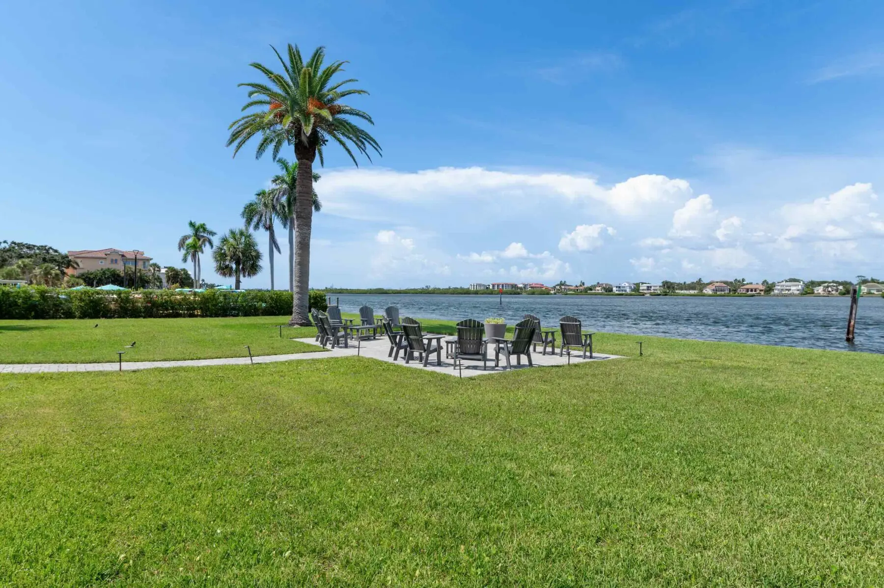 Bayfront lawn with Adirondack chairs on Siesta Key, Florida — relaxing outdoor seating for Provincial Gardens beach-to-bay guests