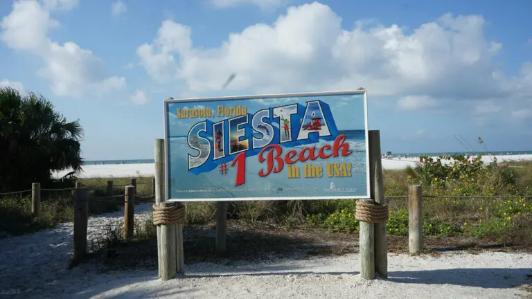 Siesta Beach entrance sign on Siesta Key, Florida, introducing the first-time visitor planning section for a Siesta Key vacation