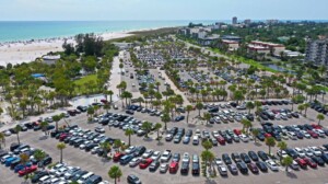 Aerial view of the Siesta Key Beach parking lot in Sarasota, Florida, showing peak arrival timing and Siesta Key beach parking demand